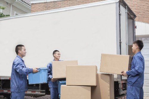 Staff wearing PPE while loading items into a van